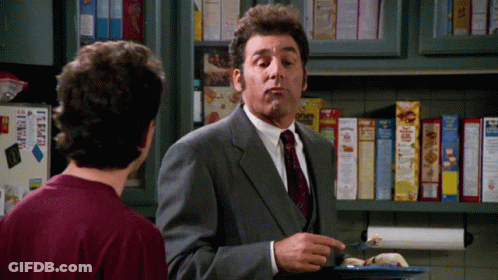 Man In Suit Talking To Another Man In Front Of Cereal Shelf GIF