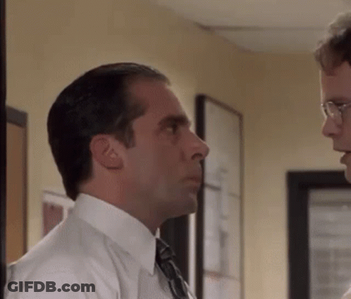 Man In Suit Talking To Another Man In Hallway GIF