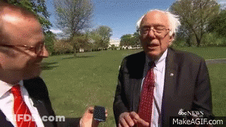 Man In Suit Talking To Another Man In Park GIF