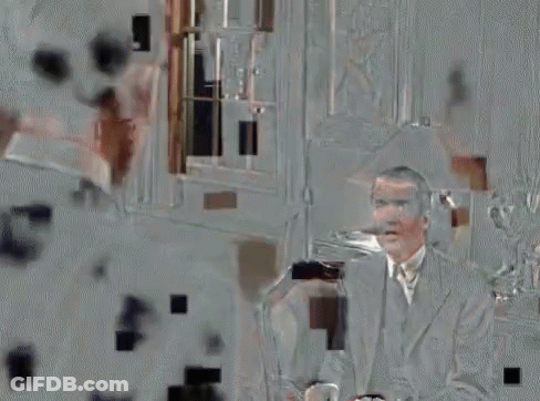 Man In Suit Talking To Another Man On Couch GIF