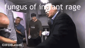 Man In Suit Talking To Another Man While Another Looks On GIF