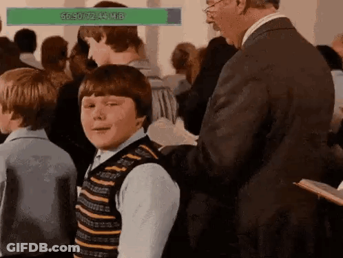 Man In Suit Talking To Boy In Crowd GIF