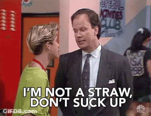Man In Suit Talking To Boy In Green Shirt GIF