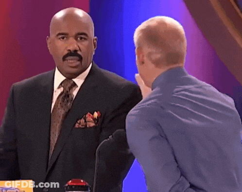 Man In Suit Talking To Man In Blue Shirt GIF