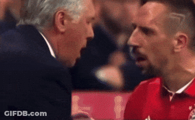 Man In Suit Talking To Man In Red Shirt GIF