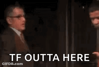 Man In Suit Talking To Man In Red Shirt GIF