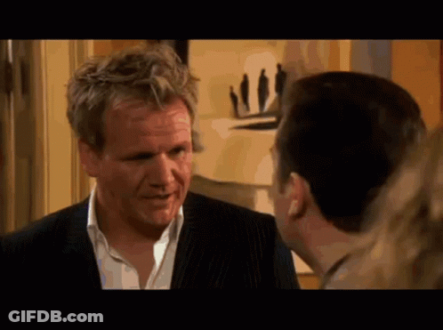 Man In Suit Talking To Man In White Shirt GIF