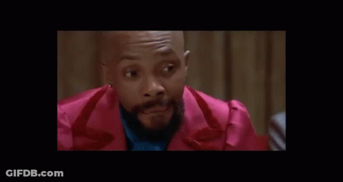 Man In Suit Talking To Man In White Shirt GIF