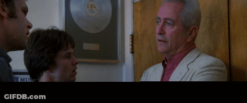Man In Suit Talking To Men At Music Club GIF