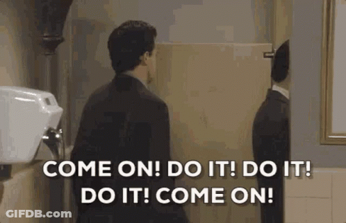 Man In Suit Talking To Reflection In Public Restroom GIF