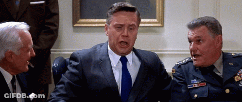 Man In Suit Talking To Two Men GIF
