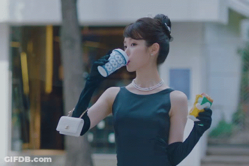 Man In Suit Talking To Woman At Counter In Lobby GIF