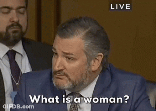 Man In Suit Talking To Woman At Table GIF