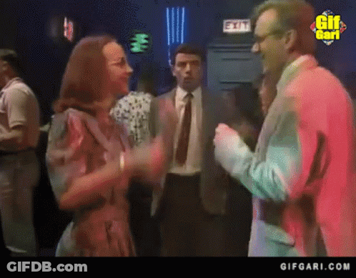 Man In Suit Talking To Woman By Exit Sign GIF