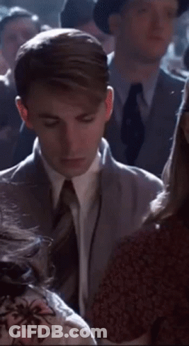 Man In Suit Talking To Woman In Crowd GIF