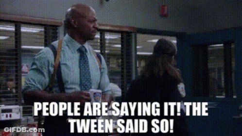 Man In Suit Talking To Woman In Police Station Holding Coffee GIF
