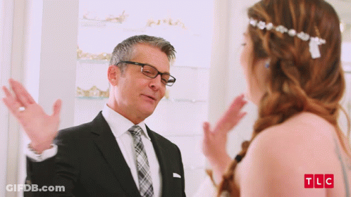 Man In Suit Talking To Woman In Wedding Dress TLC Logo GIF