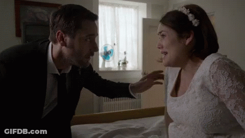 Man In Suit Talking To Woman In White Dress GIF