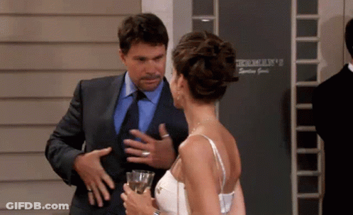 Man In Suit Talking To Woman In White Dress GIF