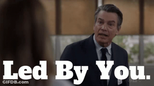 Man In Suit Talking To Woman Led By You GIF