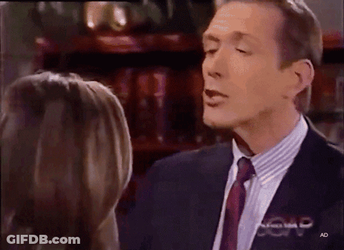 Man In Suit Talking To Woman With AD Letters GIF