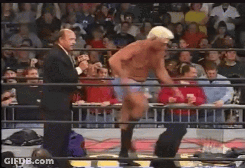 Man In Suit Talking To Wrestler In Ring GIF