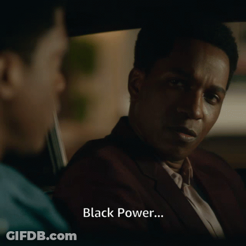 Man In Suit Talks To Another Man In Car With Black Power GIF