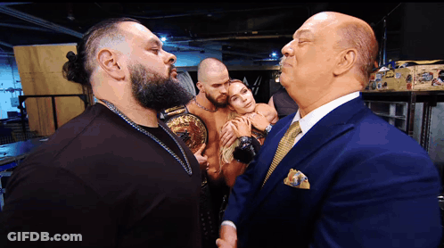 Man In Suit Talks To Man In Bearded Shirt GIF