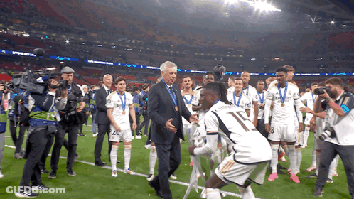 Man In Suit Talks To Soccer Player Number 17 GIF