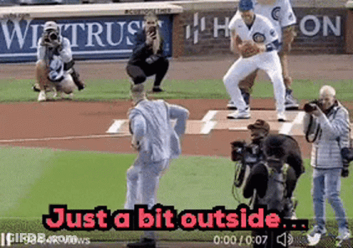 Man In Suit Throwing Baseball Just Outside GIF