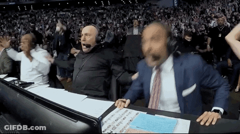 Man In Suit Tie At Desk Before Crowd GIF