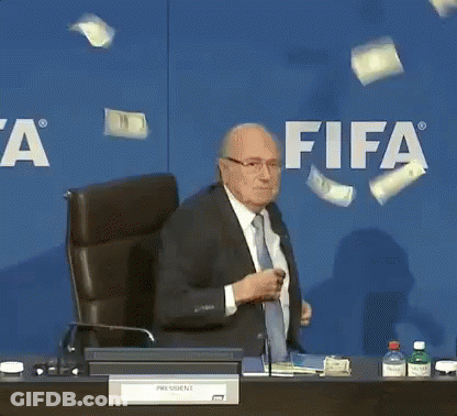 Man In Suit Tie At Desk FIFA Sign GIF