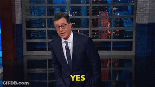 Man In Suit Tie Saying Yes At Window GIF