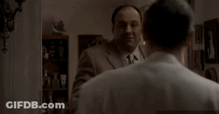 Man In Suit Touching Another's Neck GIF
