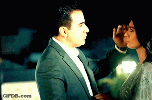 Man In Suit Touching Woman's Face GIF