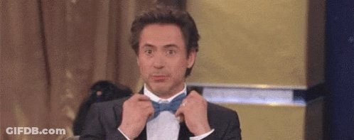 Man In Suit Tying Bow Tie GIF