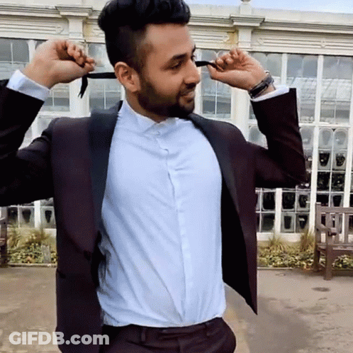 Man In Suit Tying Bow Tie GIF