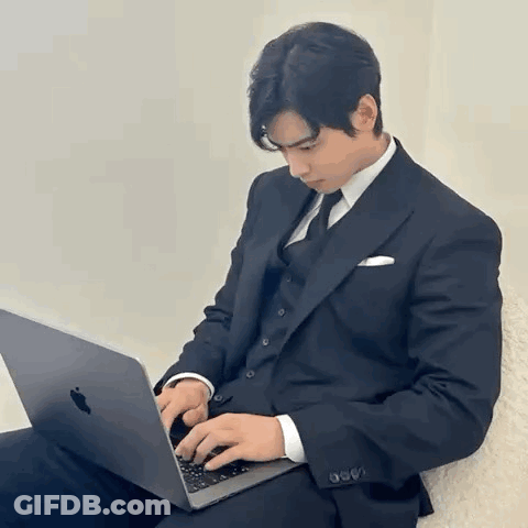 Man In Suit Typing On Laptop GIF