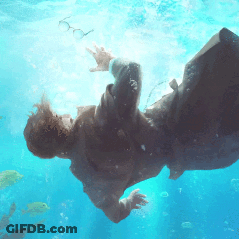 Man In Suit Underwater With Floating Glasses GIF
