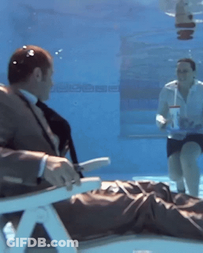 Man In Suit Underwater With Woman On Floor GIF