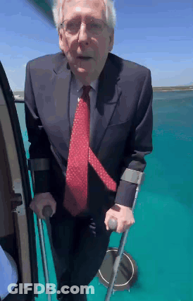 Man In Suit Using Crutches To Get Out Of Vehicle GIF