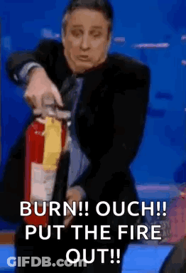 Man In Suit Using Fire Extinguisher GIF