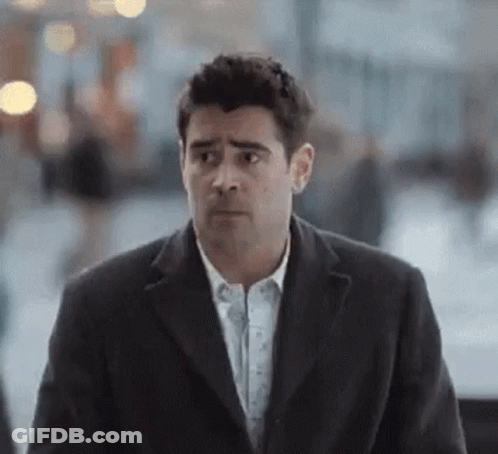 Man In Suit Walking And Looking At Camera GIF
