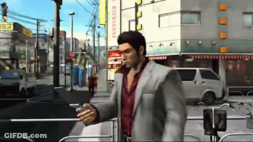 Man In Suit Walking And Looking At Phone GIF