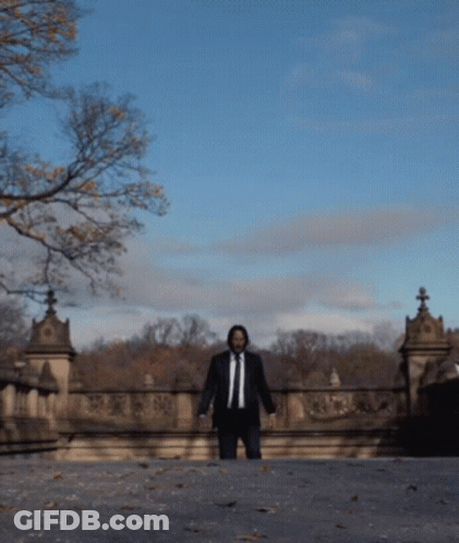 Man In Suit Walking Bridge GIF