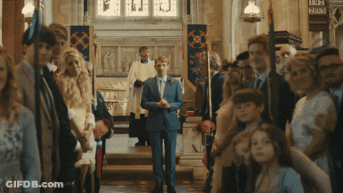 Man In Suit Walking Down Church Aisle With Sign 905 GIF