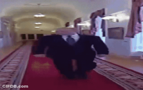 Man In Suit Walking Down Red Carpet GIF