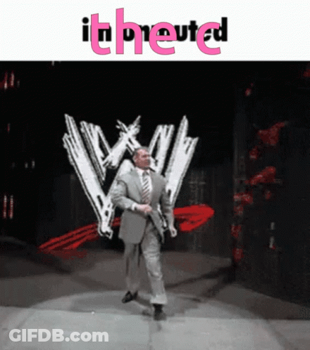 Man In Suit Walking On Stage In Front Of WW Logo GIF