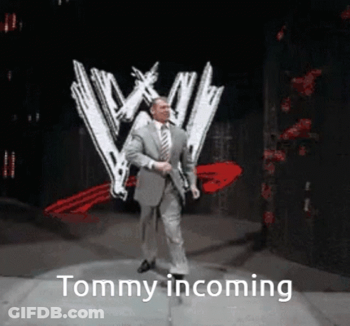 Man In Suit Walking On Stage With W Logo GIF
