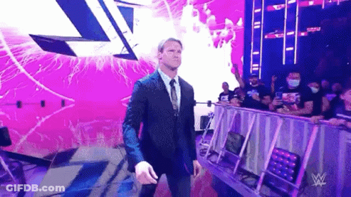Man In Suit Walking Out Of Wrestling Arena GIF
